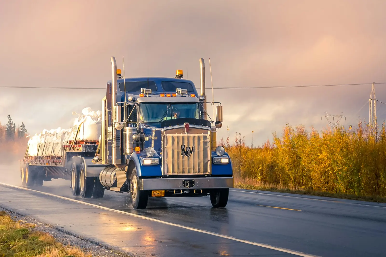 Truck carrying bagged cargo on a wet road